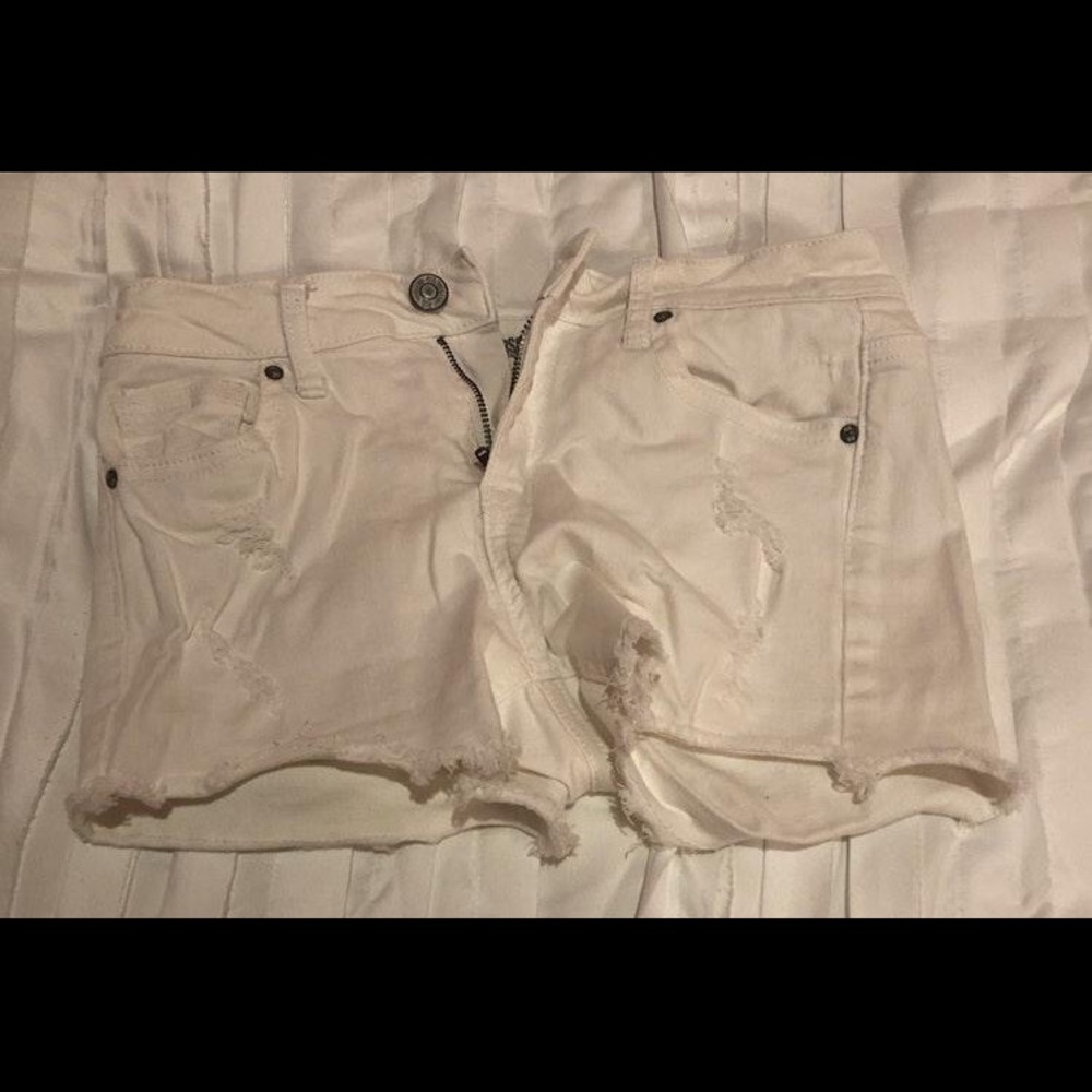 White ripped shorts